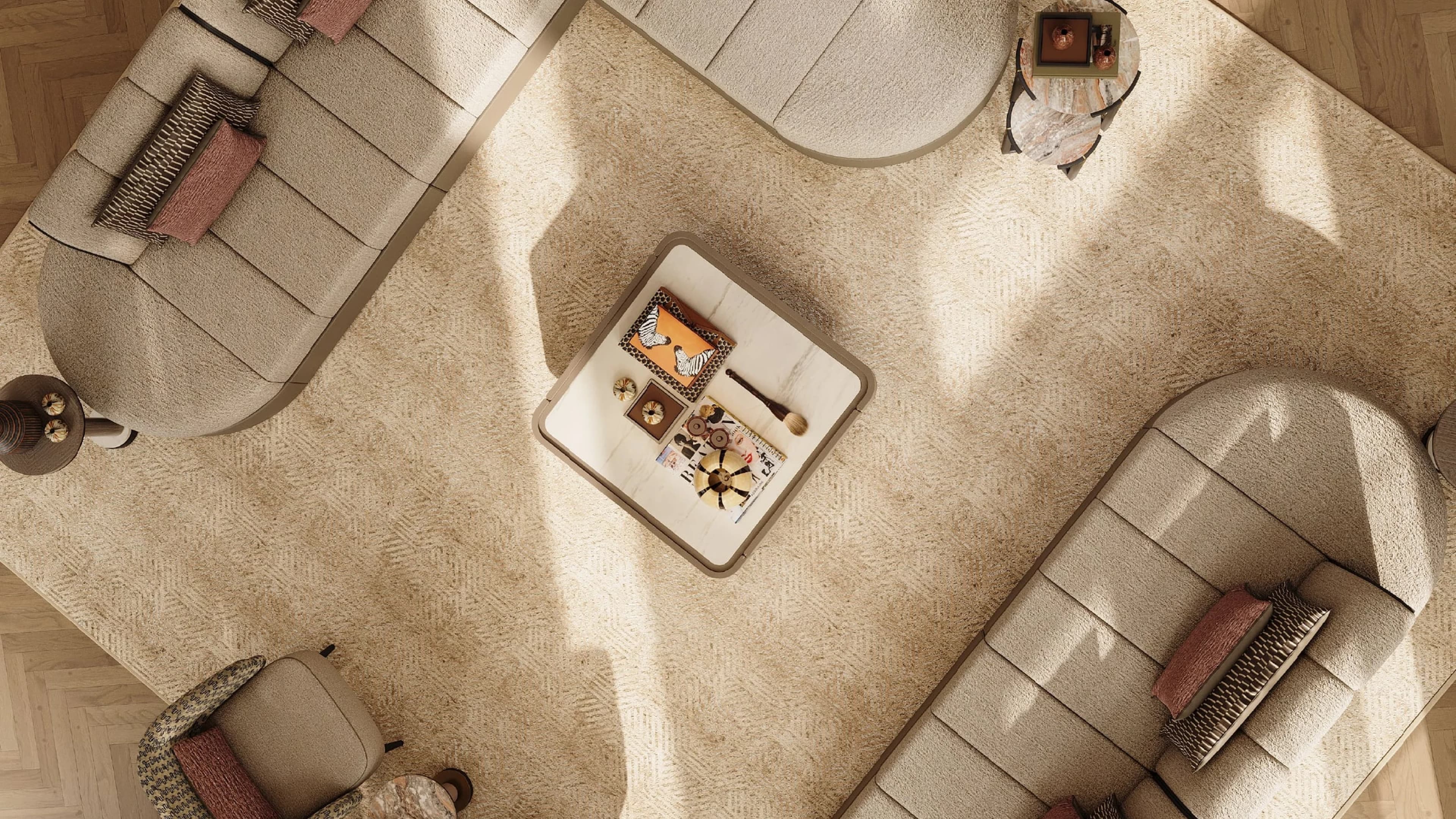 Top-down view of a living room with cream curved sofas around a low table