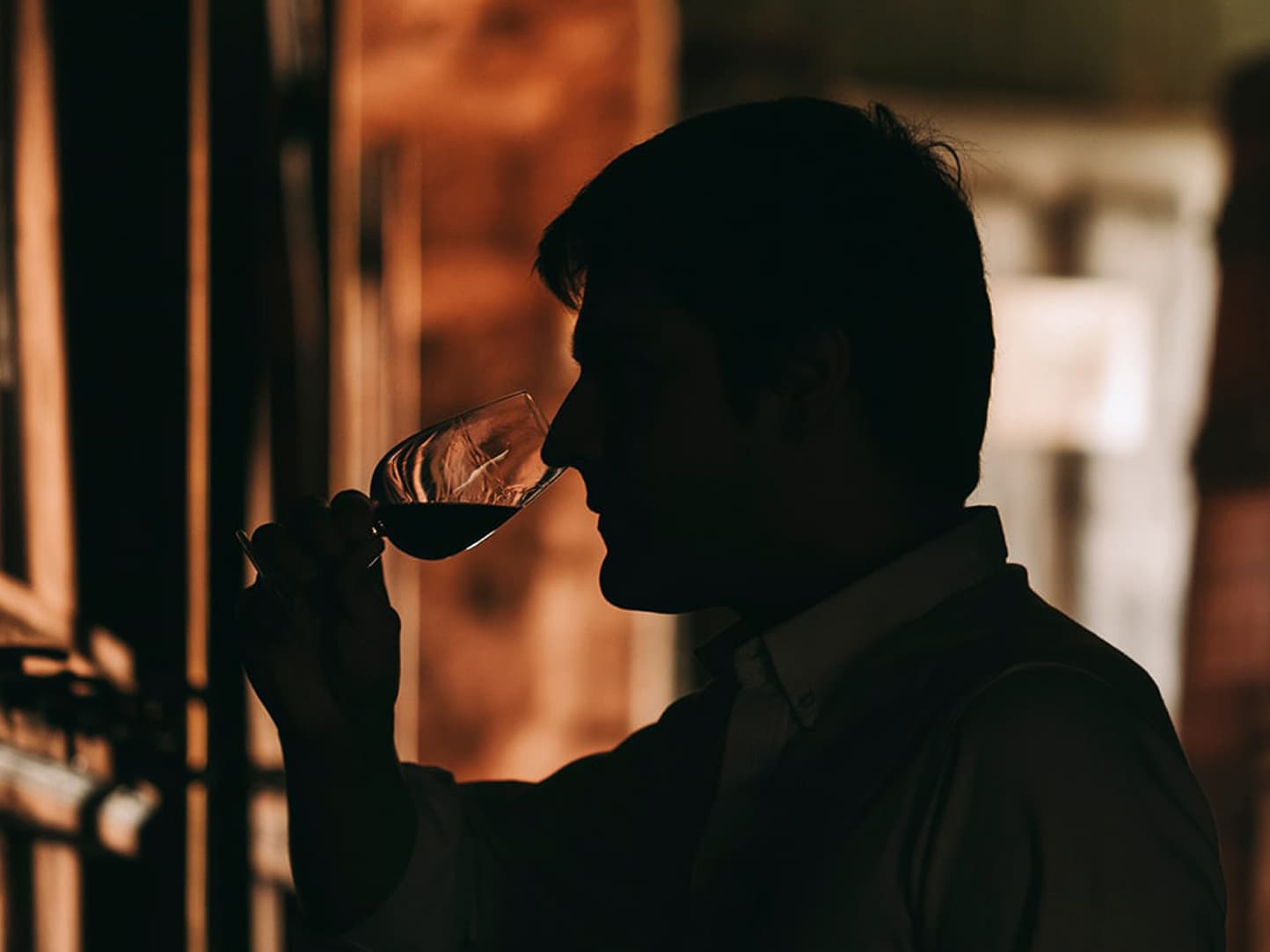 Silhouette of a man tasting red wine in the Quinta Vale D. Maria cellar